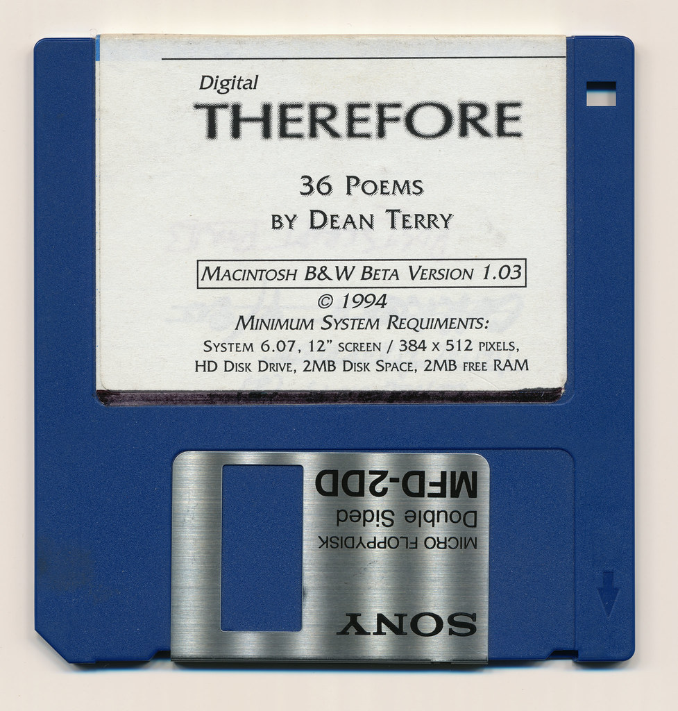 Photograph of floppy disk with label specifying poems by Dean Terry and minimum system requirements.